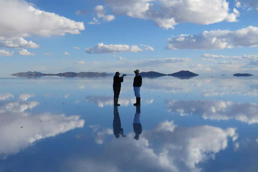Uyuni tour express from La Paz by bus - Colchani, flags, and salt-built monuments
